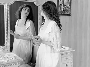 Vanities: Woman looking in mirror