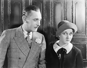 Timid: Woman looking shyly at a man next to her