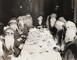 Lunching: Woman lunching with twelve Santa Clauses