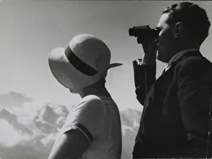 A woman and a man with binoculars