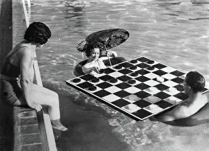 Checkers: A woman and a man playing checkers