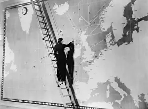 Representations: Woman marking a global map