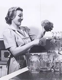 Preserves: Woman measuring preserves