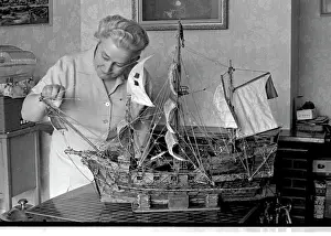 Galleon: Woman with model ship made of matchsticks