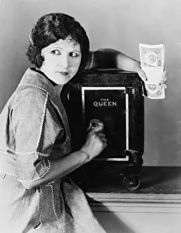Cautious: Woman with money and safe