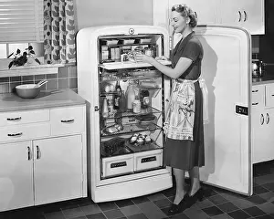 Fridge: Woman with open refrigerator