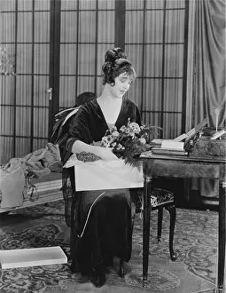 Surprises: Woman opening box of flowers