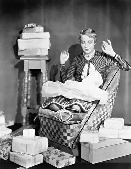 Unwrapping: Woman opening gifts