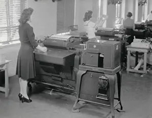 Computation: A woman operates one of 12 IBM computers in use