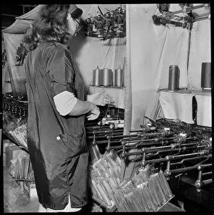 Spool: A woman operating a cop winding frame