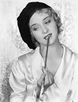 Berets: Woman with a paintbrush between her teeth