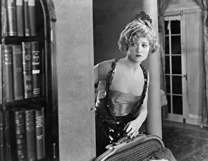 Timid: Woman peering around corner