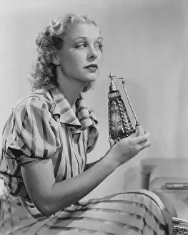 Side View: Woman with perfume atomizer
