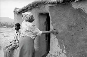 Deemed: Woman plastering walls with mud. Daggakraal was an