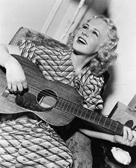 Guitars: Woman playing guitar and singing
