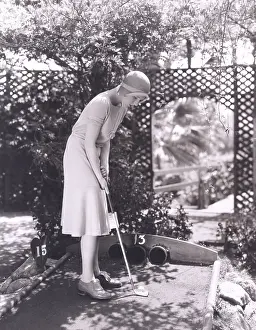 150724: Woman playing miniature golf