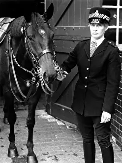 Cobblestones: Woman police officer with her horse, London