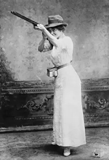Shotguns: Woman posed with shotgun for trapshooting ?