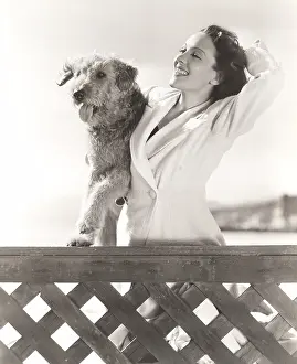 Airedale: Woman posing with her Airedale at the beach