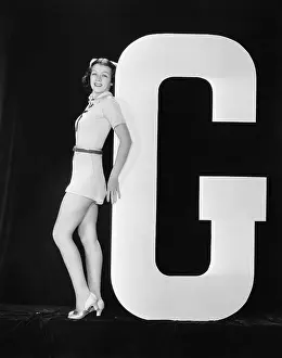 Testimonial: Woman posing with huge letter G