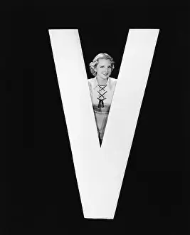 Peeking: Woman posing with huge letter V