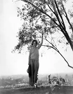 Retaining: Woman posing on top of wall