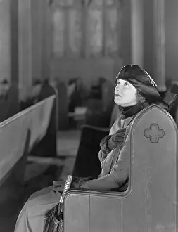 Worshiping: Woman praying in church