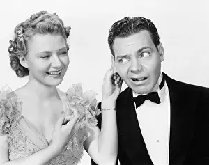 Ruffled: Woman pulling a man's ear