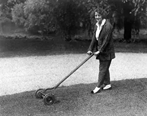 Landscaping: Woman with push mower
