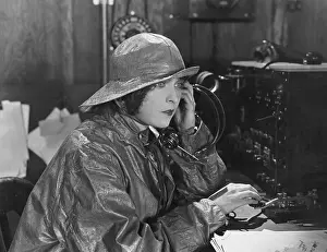 Raincoats: Woman in raincoat sending message in Morse code
