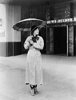 Droplets: Woman in a raincoat and umbrella