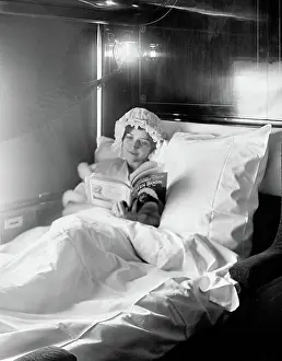 Deluxe: Woman reading in an Electric-lighted sleeper berth