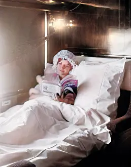 Deluxe: Woman reading in an Electric-lighted sleeper berth