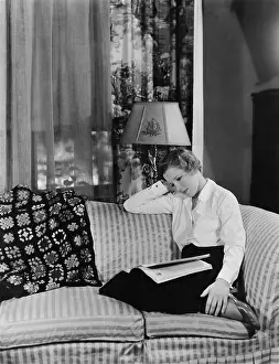 Couches: Woman reading magazine on the sofa