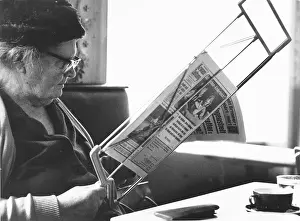 Coffeehouses: Woman reading a newspaper