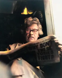 Drooping: Woman reading a newspaper on a train