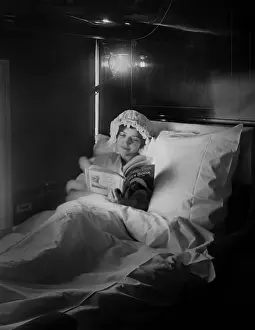 Lcgr1805: Woman reads in an electric-lighted berth on