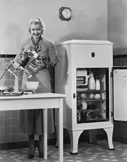 Fridge: Woman with refrigerator and mixer in kitchen