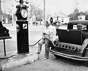 Benzine: A woman refueling, 1932
