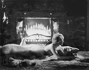 Sumptuous: Woman relaxing on bear rug in front of fire