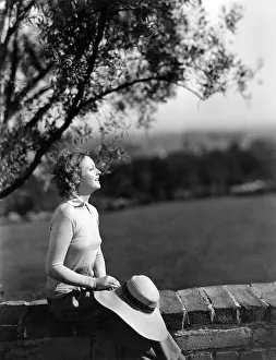 Retaining: Woman resting against wall