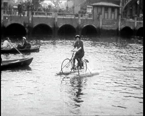 Contraption: Woman Riding Along A River on a Floating Bicycle