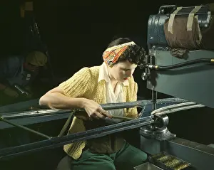 Accuracy: A woman riveting machine operator at an aircraft