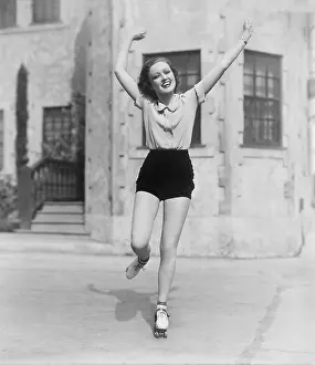 Rollerskating: Woman roller-skating on a side walk