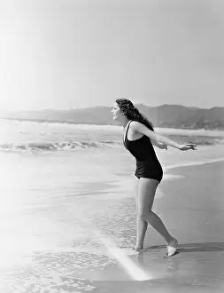 Long Haired: Woman running into the water at the beach