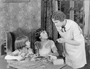 Sibling: Woman scolding her two daughters for playing with