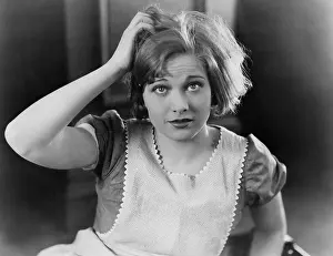 Scratching: Woman scratching her head