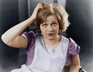 Scratching: Woman scratching her head