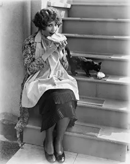 Indulge: Woman sharing pie with cat
