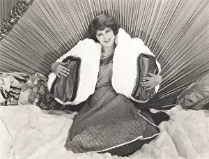 Headboard: Woman sitting in bed with pillows